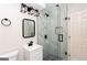 Bathroom featuring frameless glass shower, modern fixtures, black hardware, and sleek design at 504 Milligan Dr, Stone Mountain, GA 30083