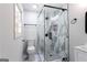 Modern bathroom features glass-enclosed shower, marble tile, new toilet and contemporary finishes at 504 Milligan Dr, Stone Mountain, GA 30083