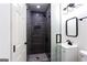 Sleek modern bathroom with glass shower, black fixtures, and elegant vanity with sink at 504 Milligan Dr, Stone Mountain, GA 30083