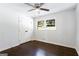 Bright bedroom features a ceiling fan, hardwood floors, a closet, and a view to the street at 504 Milligan Dr, Stone Mountain, GA 30083