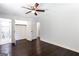 Bedroom features hardwood floors, ceiling fan and ensuite bathroom with modern glass shower at 504 Milligan Dr, Stone Mountain, GA 30083