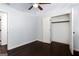 Bedroom with dark hardwood floors, ceiling fan and closet with white doors at 504 Milligan Dr, Stone Mountain, GA 30083