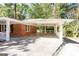 Attached carport offering covered parking and convenient access to the home, featuring a brick exterior at 504 Milligan Dr, Stone Mountain, GA 30083