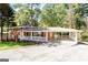Charming single-Gathering home with a brick exterior, large carport, well-maintained lawn, and inviting curb appeal at 504 Milligan Dr, Stone Mountain, GA 30083