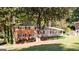 Brick home with covered carport nestled among mature trees, providing both shade and privacy at 504 Milligan Dr, Stone Mountain, GA 30083