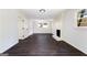 Open living room with white brick fireplace, dark hardwood floors and recessed lighting at 504 Milligan Dr, Stone Mountain, GA 30083