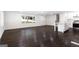 Spacious open-concept living room with dark hardwood floors, updated kitchen and stairs at 504 Milligan Dr, Stone Mountain, GA 30083