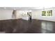 Open-concept living room featuring dark hardwood floors, renovated kitchen, and updated lighting at 504 Milligan Dr, Stone Mountain, GA 30083