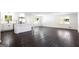 Spacious open-concept living room featuring dark hardwood floors and a bright, renovated kitchen at 504 Milligan Dr, Stone Mountain, GA 30083