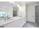 Bright bathroom featuring double vanity with quartz countertop and modern fixtures next to glass shower at 241 Ben Horton Dr, Mcdonough, GA 30253