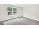 Bright bedroom features neutral carpet, and large window with private backyard view at 241 Ben Horton Dr, Mcdonough, GA 30253