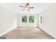 Bright bedroom with three windows and a ceiling fan at 241 Ben Horton Dr, Mcdonough, GA 30253