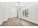 Bright dining room with natural light, wood floors, and modern chandelier at 241 Ben Horton Dr, Mcdonough, GA 30253