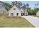 Charming home featuring symmetrical windows, neutral shutters, and manicured lawn at 241 Ben Horton Dr, Mcdonough, GA 30253
