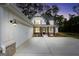 Charming home featuring a white exterior, garage, and inviting front porch at dusk at 241 Ben Horton Dr, Mcdonough, GA 30253