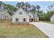 Classic home showcasing a white exterior, symmetrical windows, and well-manicured landscaping at 241 Ben Horton Dr, Mcdonough, GA 30253