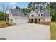 Beautiful home featuring a white exterior, well-manicured lawn, and a spacious driveway at 241 Ben Horton Dr, Mcdonough, GA 30253