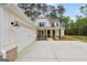 Attractive home showcasing a white exterior, two-car garage, and well-kept landscaping at 241 Ben Horton Dr, Mcdonough, GA 30253