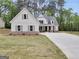 Charming white farmhouse-style home with a welcoming front porch, gray shutters and a freshly sodded lawn at 241 Ben Horton Dr, Mcdonough, GA 30253