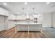 Open kitchen design featuring an oversized island with modern cabinets and lighting at 241 Ben Horton Dr, Mcdonough, GA 30253