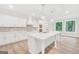 Gourmet kitchen with oversized island, custom cabinets, and modern pendant lights at 241 Ben Horton Dr, Mcdonough, GA 30253
