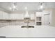 Modern kitchen featuring a large island, stylish pendant lighting, and ample storage at 241 Ben Horton Dr, Mcdonough, GA 30253