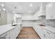 Bright kitchen featuring white cabinets, a large island, and stainless steel appliances at 241 Ben Horton Dr, Mcdonough, GA 30253
