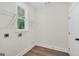 Clean laundry room features hookups, window and storage racks at 241 Ben Horton Dr, Mcdonough, GA 30253