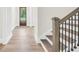 Elegant staircase with wood railing and iron balusters leading to the next level at 241 Ben Horton Dr, Mcdonough, GA 30253