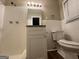 Bathroom with neutral colors, updated vanity, and a shower with white tiled walls at 3086 Meadow Lark Ln, East Point, GA 30344