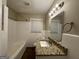 Bright bathroom features white tile walls, granite vanity, and a combination tub/shower at 3086 Meadow Lark Ln, East Point, GA 30344