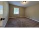Cozy bedroom with neutral paint, carpet flooring, and a window for natural light at 3086 Meadow Lark Ln, East Point, GA 30344