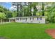 Charming single-story home features a large front lawn and a welcoming entryway with white stairs at 3086 Meadow Lark Ln, East Point, GA 30344
