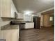 Modern kitchen featuring white cabinets, granite countertops, stainless steel appliances, and wood-look floors at 3086 Meadow Lark Ln, East Point, GA 30344
