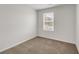 Simple bedroom with neutral walls, carpet, and one window at 209 Weldon Rd # 43, Mcdonough, GA 30253