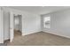 Spacious bedroom with neutral walls and carpet, plus an open view to a hallway at 209 Weldon Rd # 43, Mcdonough, GA 30253