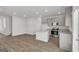 Modern kitchen with island, stainless steel appliances, and light wood floors at 209 Weldon Rd # 43, Mcdonough, GA 30253