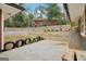 View of the unfinished backyard featuring a retaining wall and patio area at 1973 Glendale Dr, Decatur, GA 30032