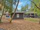 Backyard view of house featuring a grassy area covered in leaves at 1973 Glendale Dr, Decatur, GA 30032