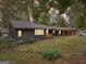 This single-Gathering home features a dark exterior, green grass and mature trees at 1973 Glendale Dr, Decatur, GA 30032