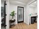 Inviting hallway featuring wood floors, stylish decor and access to outdoor area at 1973 Glendale Dr, Decatur, GA 30032