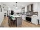Modern kitchen features white cabinetry, stainless steel appliances, gray island, and decorative backsplash at 1973 Glendale Dr, Decatur, GA 30032