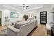 Open-concept living room with a view of the kitchen and dining area, and a sleek gray sofa at 1973 Glendale Dr, Decatur, GA 30032
