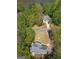 Overhead shot of two homes in a verdant setting, one with lake access at 22 Agean Way, Whitesburg, GA 30185