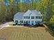 Attractive two-story home featuring classic architectural details and a well-kept front yard with shrubbery at 22 Agean Way, Whitesburg, GA 30185