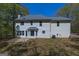 Rear exterior view of the two-story home featuring a patio and a well-manicured yard at 22 Agean Way, Whitesburg, GA 30185