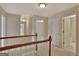 Upstairs hallway with neutral paint and carpet; doors to bedrooms and bathrooms at 22 Agean Way, Whitesburg, GA 30185