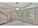Bright room with views of the front entrance and staircase; neutral carpet and paint at 22 Agean Way, Whitesburg, GA 30185