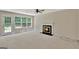 Bright living room with a fireplace and a door that leads to the backyard at 22 Agean Way, Whitesburg, GA 30185