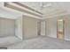 Spacious main bedroom featuring tray ceiling, ceiling fan and access to the ensuite bathroom at 22 Agean Way, Whitesburg, GA 30185